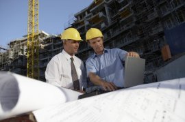 Construction managers oversee businesses at a building site.