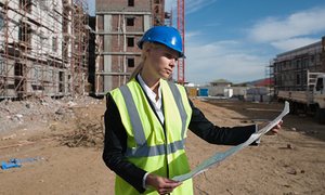 women on building site keeping website papers